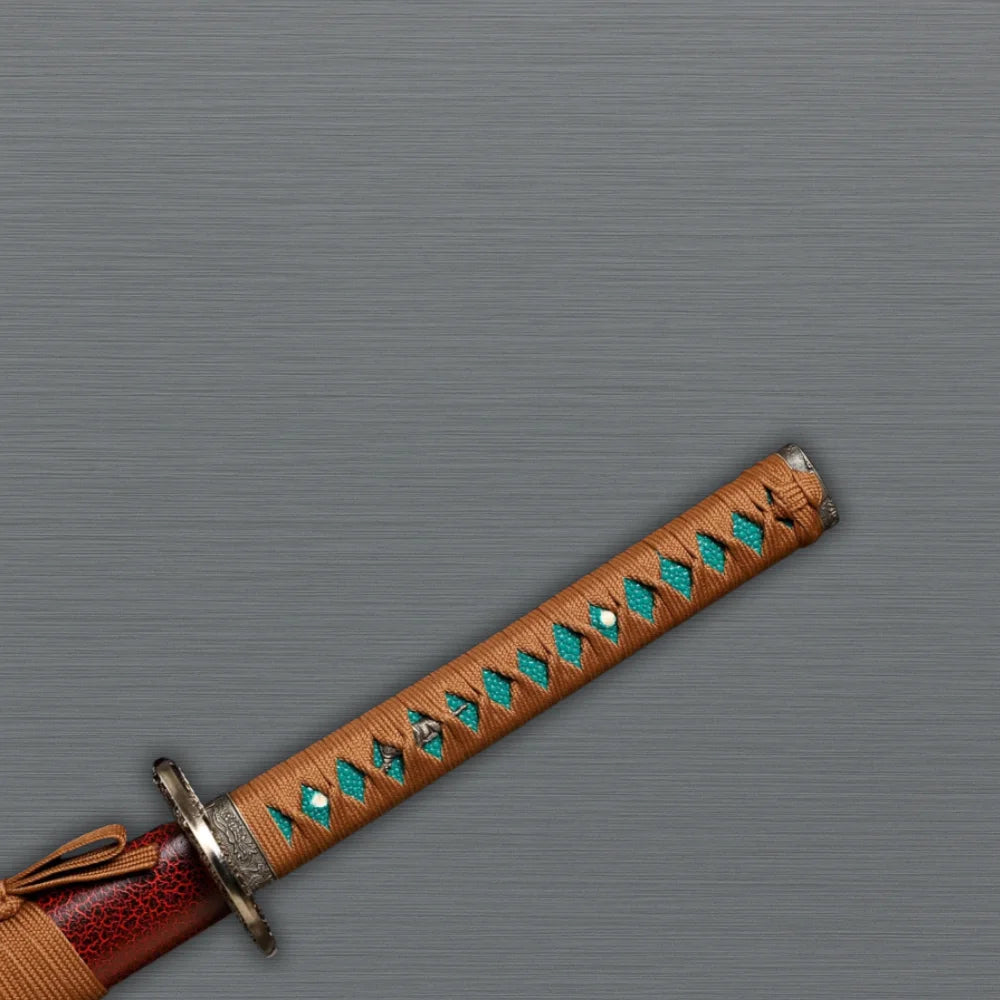 Red-themed Japanese katana handle and tsuba